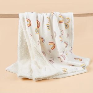 Thick infant swaddle blanket with rainbow print and soft white sherpa fleece lining