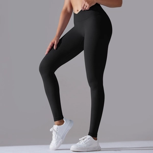 Detail of high-waist seamless black yoga pants featuring a v-shaped crossover waistband