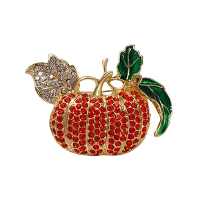 Sparkling pumpkin brooch with red rhinestones and green enamel on gold metal base