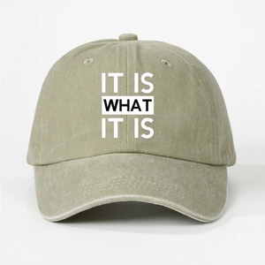 Detailed texture of olive green washed cotton baseball cap with IT IS WHAT IT IS print