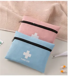 Detail of cationic fabric first aid kits in pink and blue with white cross medical logo