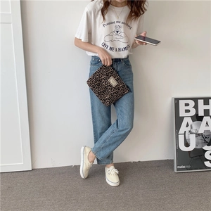 Lifestyle shot of a leopard print canvas clutch paired with casual Korean fashion attire