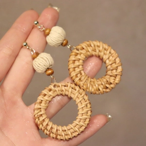 Handmade oversized bohemian rattan hoop earrings with wooden beads for summer vacations