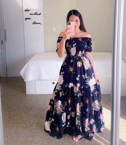 Detailed close-up of smocking waist and floral print on this off-shoulder maxi dress