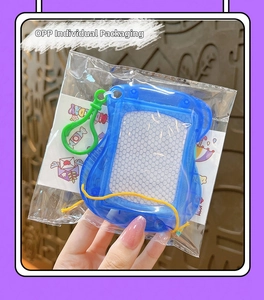 Detailed view of mini magnetic drawing board keychain in clear blue with cartoon card insert