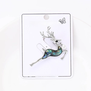 Detail of elk brooch with iridescent shell inlay, white pearl, and sparkling rhinestones