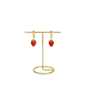 Charming red strawberry pendant earrings with green leaves on a gold earring buckle