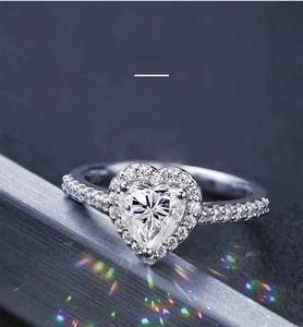 Macro detail of one carat heart-shaped moissanite engagement ring with micro-pave diamonds