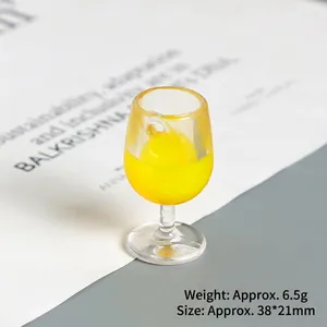 Detailed view of mini resin wine glass charm with yellow filling and hanging loop