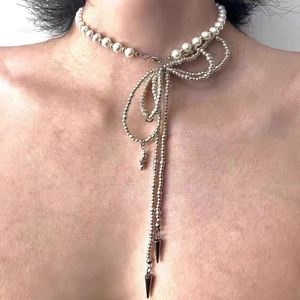 Macro detail of Y2K star necklace with white pearls and silver beaded metal chains
