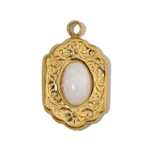 Close-up of vintage oval white stone pendant with gold embossed stainless steel border
