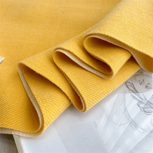 Close-up of yellow imitation cashmere scarf fabric showing soft woven texture and drape