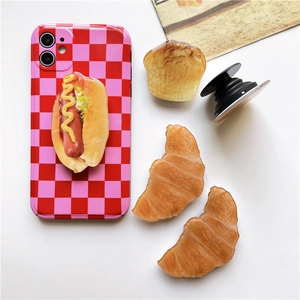 Detailed close-up of realistic 3D food phone grips and a red checkered phone case set
