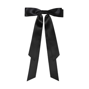 Detail view of large black satin ribbon bow hair clip with long flowing streamers