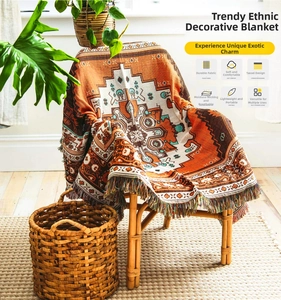 Detail of bohemian cotton woven throw with geometric patterns and colorful tassels on chair
