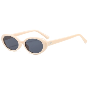 Retro oval beige sunglasses with dark grey lenses and minimalist vintage aesthetic design