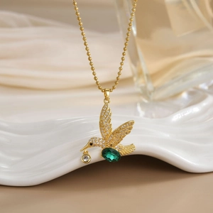 Elegant gold hummingbird pendant necklace with emerald green stone and white zircon stones
