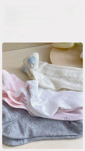 Detail of breathable mesh cotton socks featuring sweet bow embroidery and soft ribbed cuffs