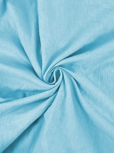 Macro shot of light blue linen fabric texture with a spiral fold layout for men's shirts