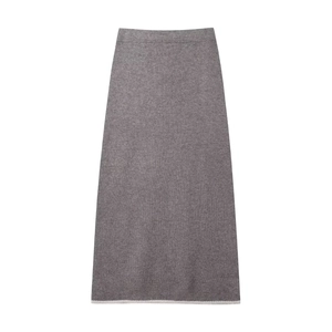 Detail of grey knitted midi skirt with elastic waist and contrast trim on white background