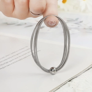 Elastic silver stainless steel spring bracelet featuring a minimalist metal ball charm