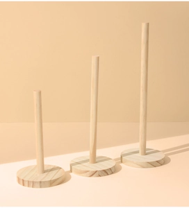 Three varying height wooden pillar stands with natural grain for jewelry display