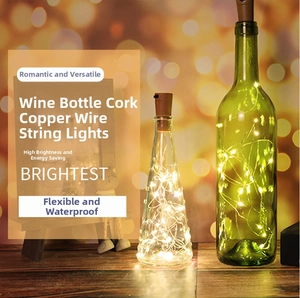 Macro detail of warm white copper wire LED lights inside decorative glass wine bottles
