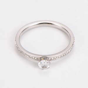 Macro shot of silver stainless steel six-prong ring with side pavé diamond setting