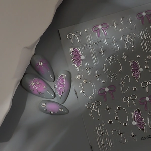 Detail of 5D gel butterfly nail stickers with silver metallic accents and star elements