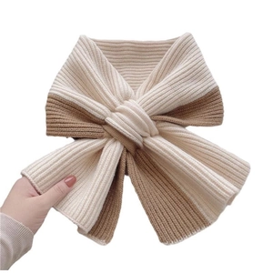 Close-up of rib-knit scarf showing soft texture and bicolor cream brown stitching detail