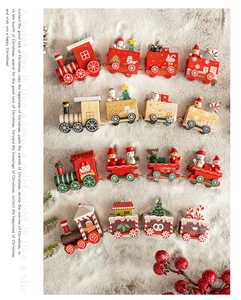 Detailed overhead view of four wooden Christmas train sets with snow texture background