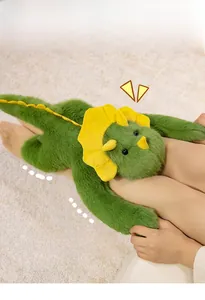 Detail of soft green triceratops plush showing plush texture and yellow frills