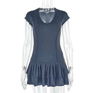 Detail of V-neck fitted short sleeve dress with double layered pleated skirt hem