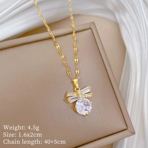 Detailed view of gold butterfly pendant with white zircon and jewelry specifications