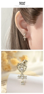 Macro shot of silver heart and cross stud earring with micro-pave cubic zirconia crystals