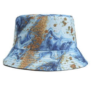 Detailed view of fluid art marble pattern and gold metallic spots on bucket hat