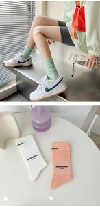 Close-up of ribbed cuffs and letter print on cotton mid-calf sports socks in pastel colors
