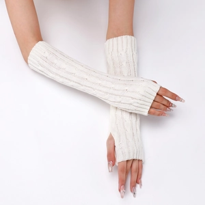 Detail of cable knit fingerless gloves in cream white showing arm warmer texture