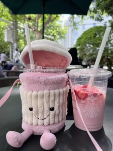 Pink plush cartoon cup holder with smiling face and shoulder strap for coffee cups