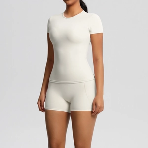 Detail of ivory yoga set showing tight fit fabric texture and high waist short cut