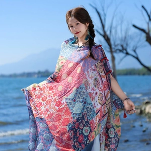 Detail of red Bohemian floral beach shawl wrap with lightweight sheer chiffon fabric