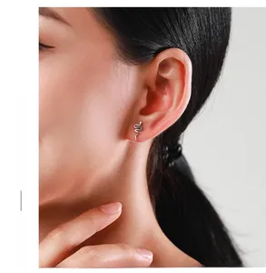 Close-up of S925 sterling silver snake earrings worn on a model with polished finish