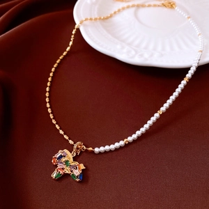 Close-up of vintage 18K gold plated horse necklace with colorful gems and white pearls
