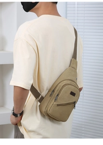 Detail of beige canvas chest bag featuring adjustable strap and front zipper pocket