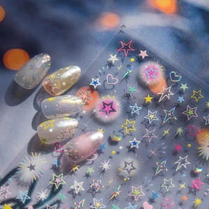 Macro shot of 3D embossed colorful star and heart nail stickers with laser effect