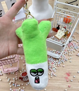 Macro detail of plush scallion pendant showing soft texture and metal keyring clasp