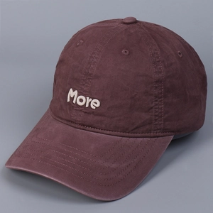 Detailed close-up of More letter embroidery on vintage washed cotton baseball cap