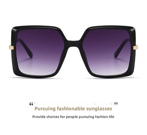 Detail of classic square sunglasses with black frames and purple gradient lenses