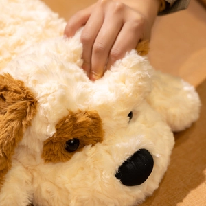 Close-up of soft plush dog toy face showing fluffy texture and gentle hand stroking