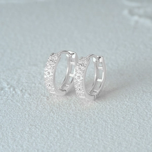 Close-up of S925 sterling silver square hoop earrings with sparkling cubic zirconia stones